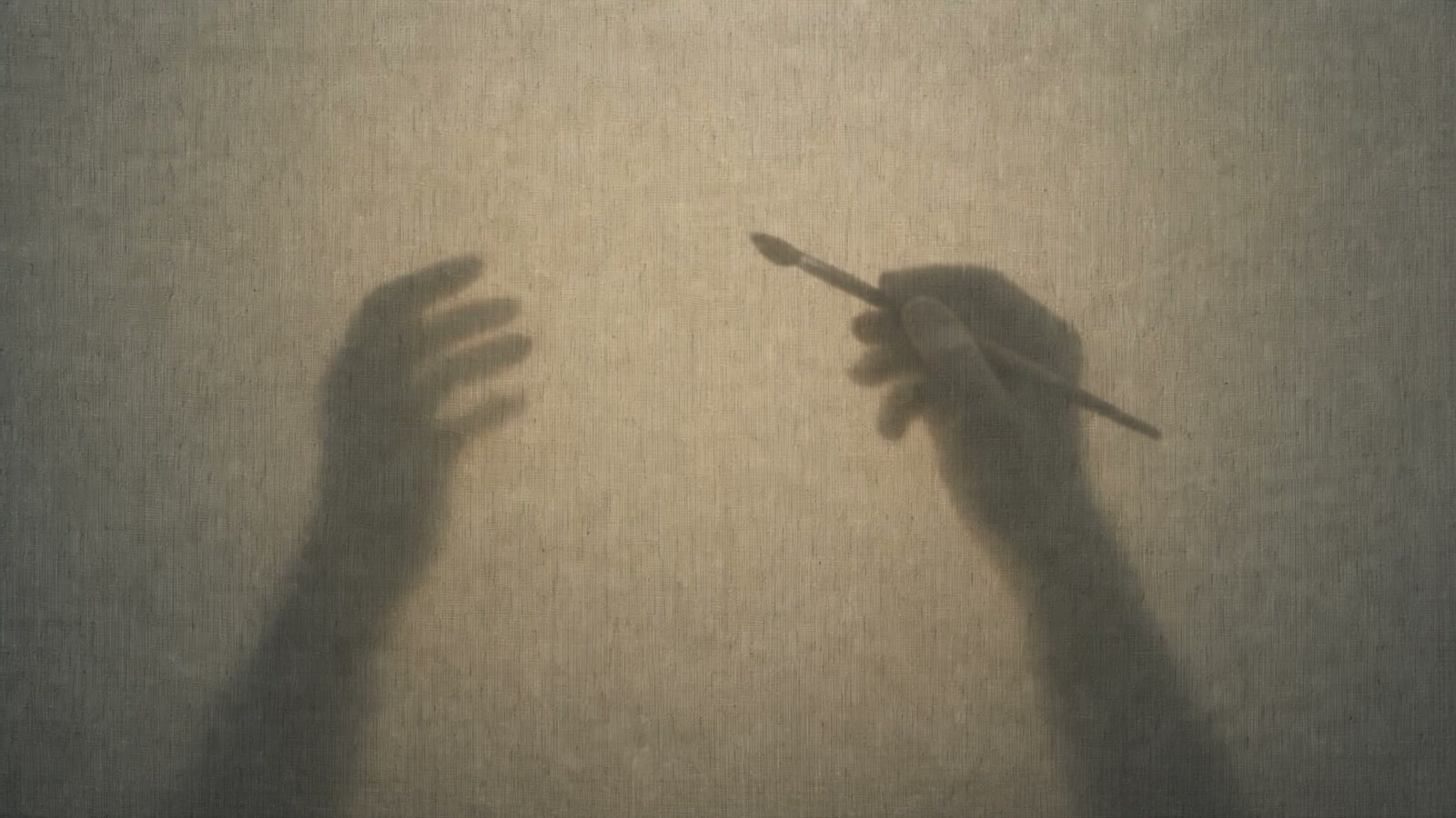 Two hands and a paintbrush behind a backlit canvas